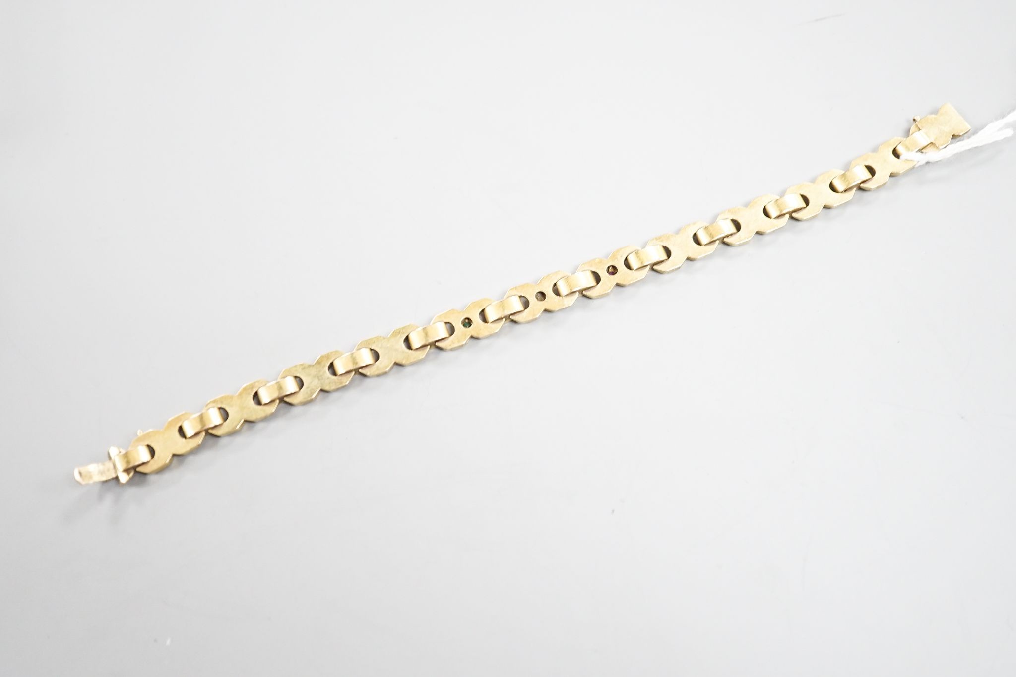 A modern continental yellow, metal, ruby, emerald and diamond set bracelet, 18.3cm, gross weight 14.5 grams.